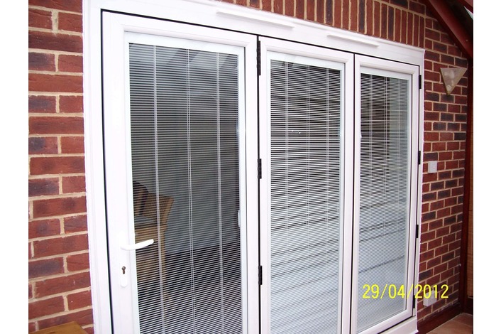 White upvc bifold door with blinds