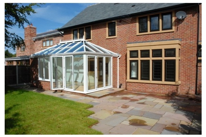 Convervatory featuring white-framed bi-folds.